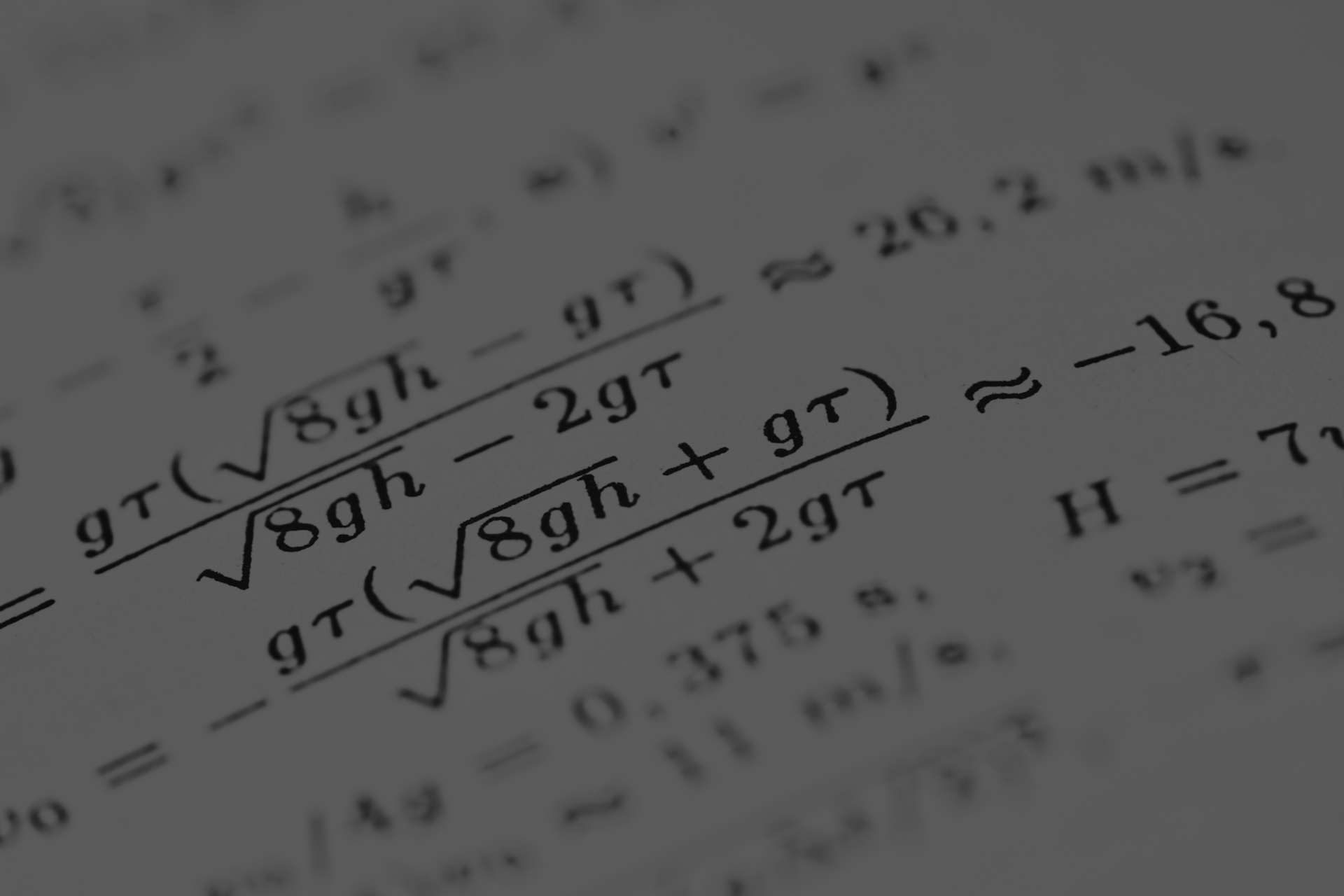 Mathematical formulas are shown on the paper.